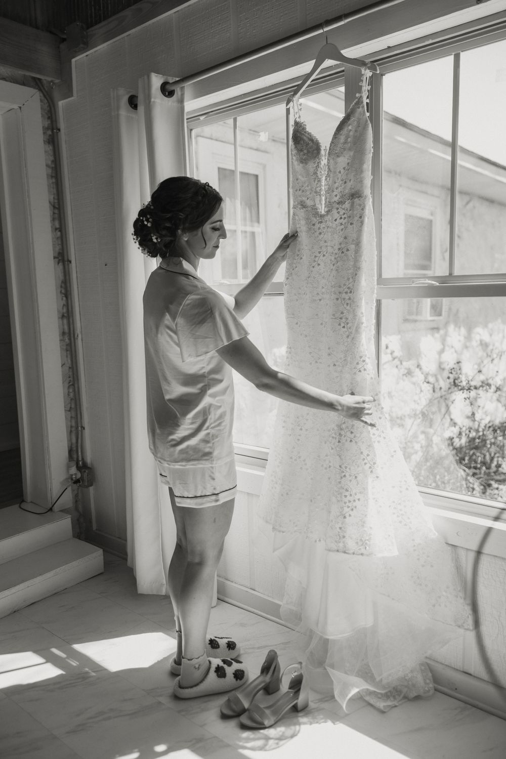 A series of black and white photos showing someone adjusting white lace curtains in a sunlit window.