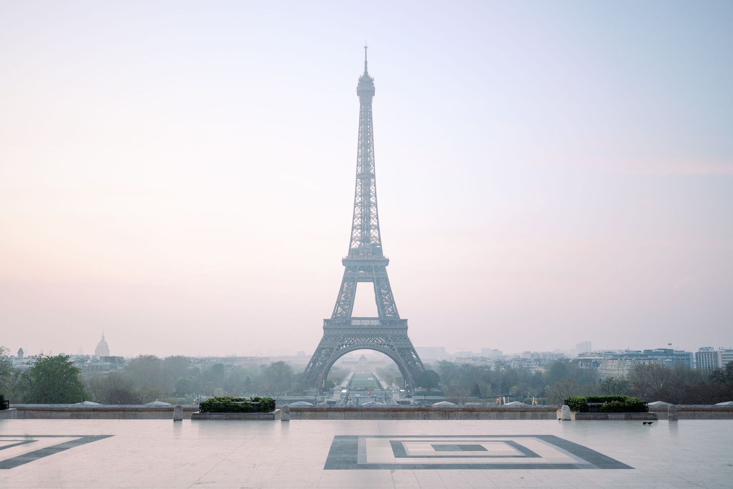 Panoramic collage of the Eiffel Tower in Paris at different times of day showing the iconic landmark against changing skies.