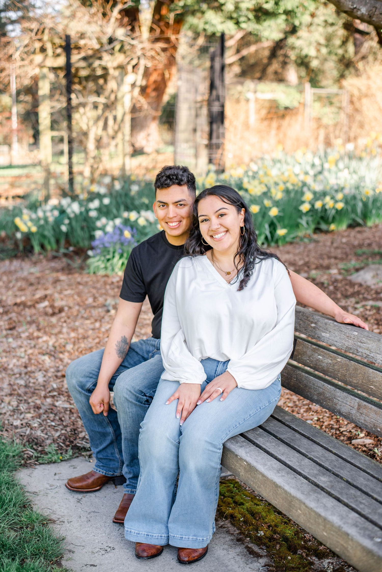 A couple in coordinated blue outfits share intimate moments in a series of outdoor photos among trees.