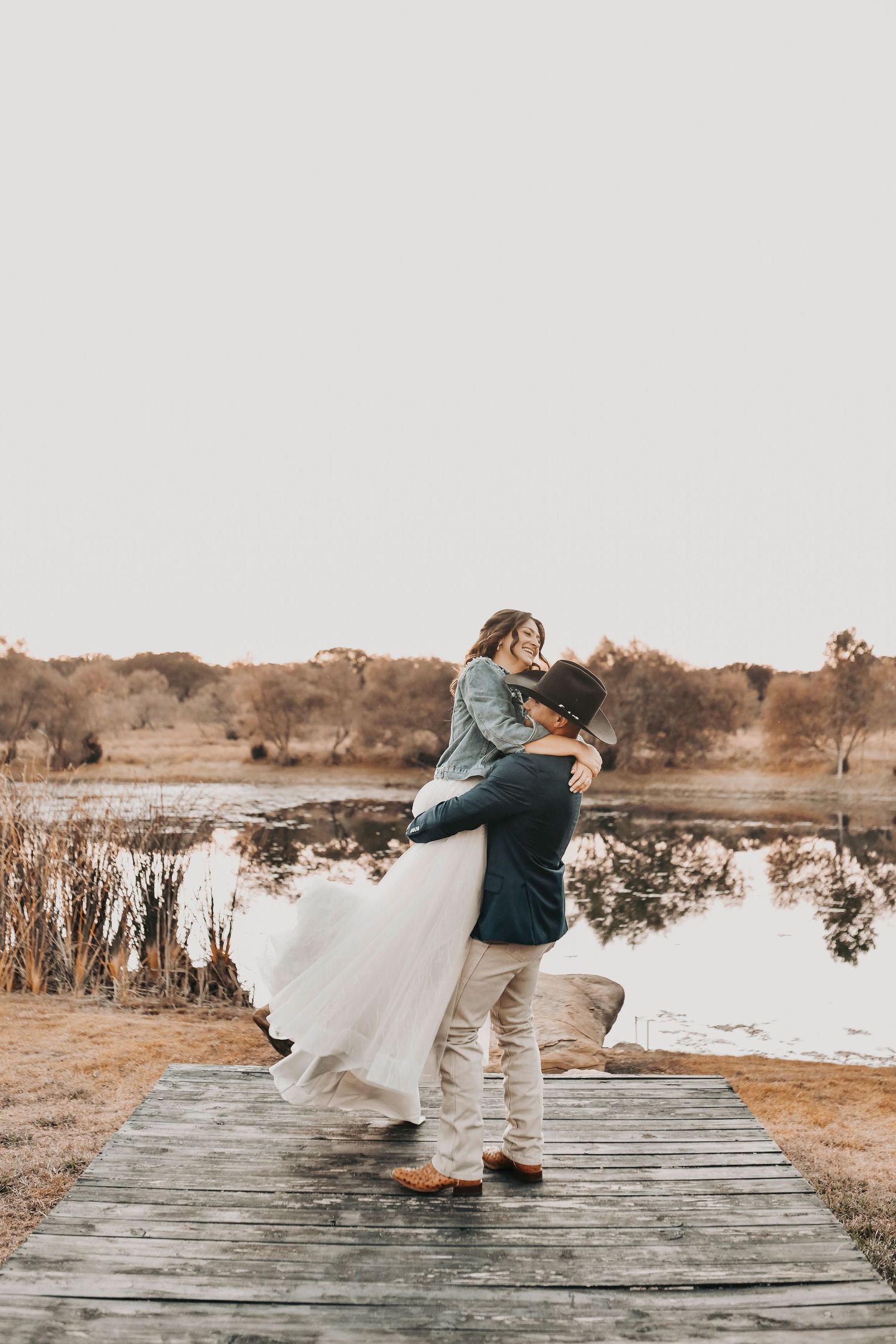 Sunset bride and groom photos by pond at The Barn at Paradise