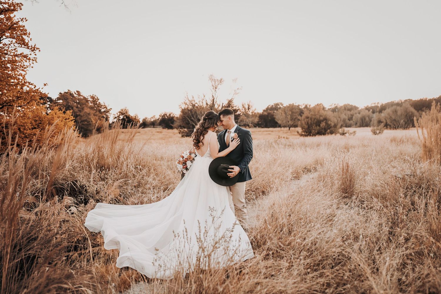golden sunset photos of bride and groom at barn at paradise