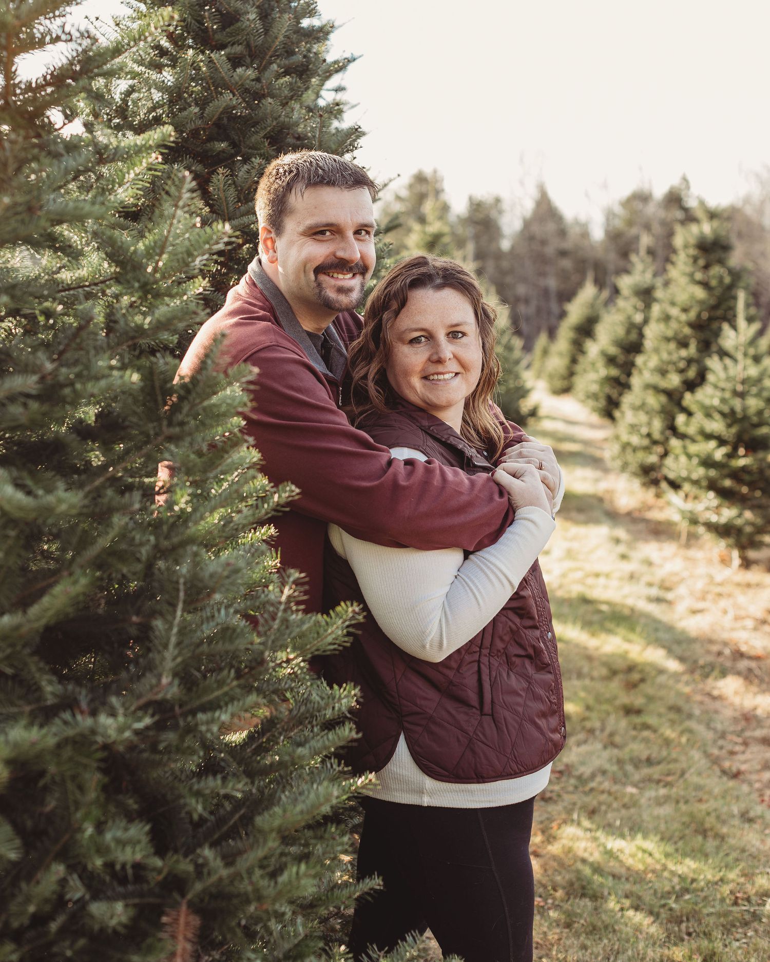 professional photo of a couple at a tree farm