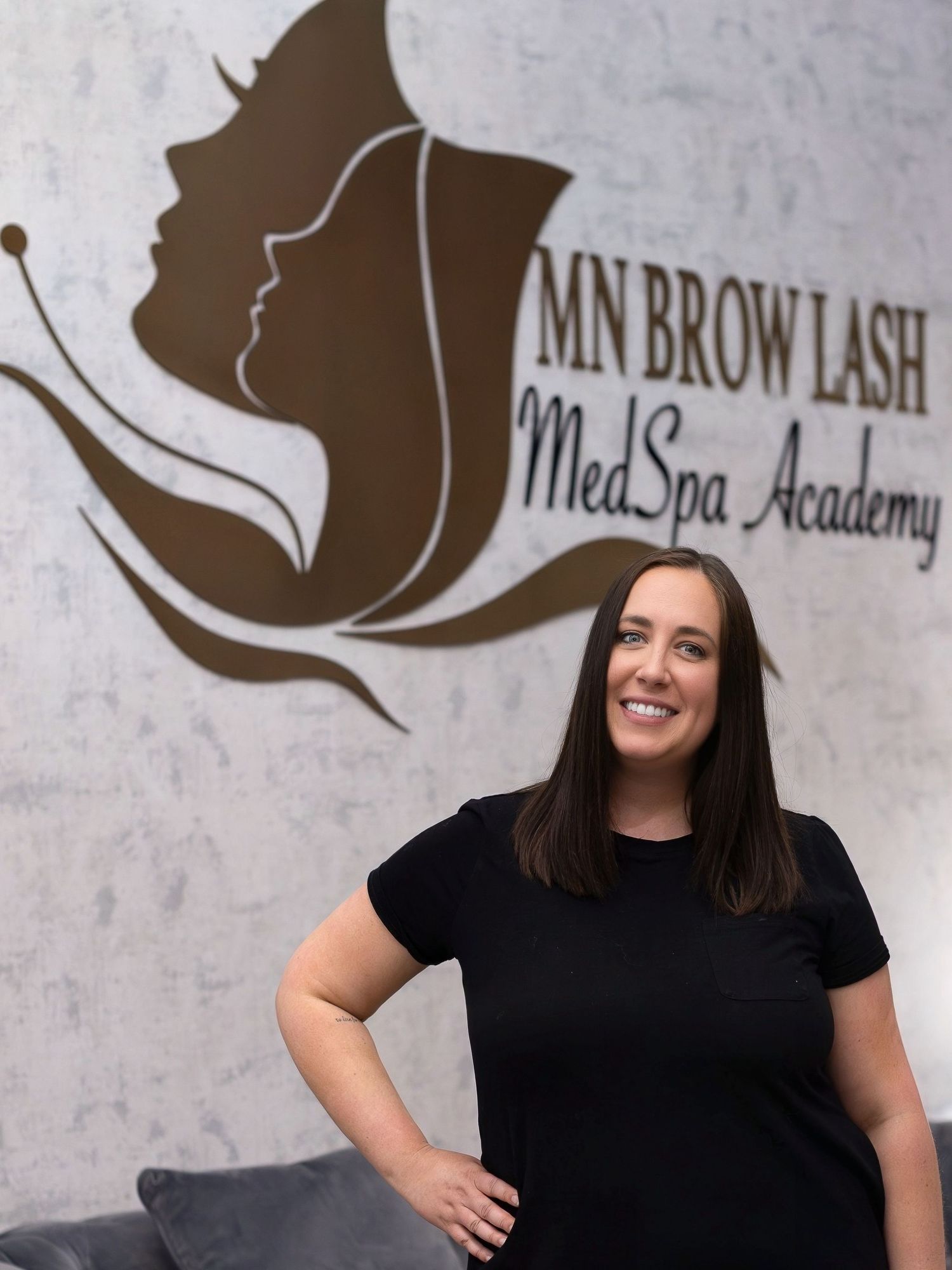 Professional spa business logo and storefront with team member in black shirt.
