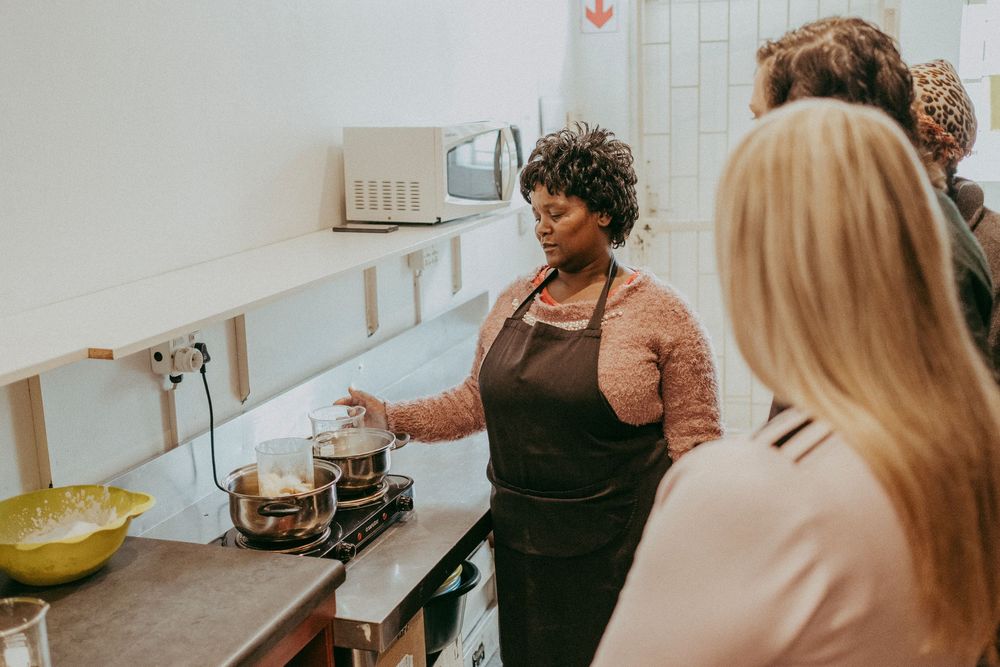 Instructor demonstrating how to mix ingredients for skincare products