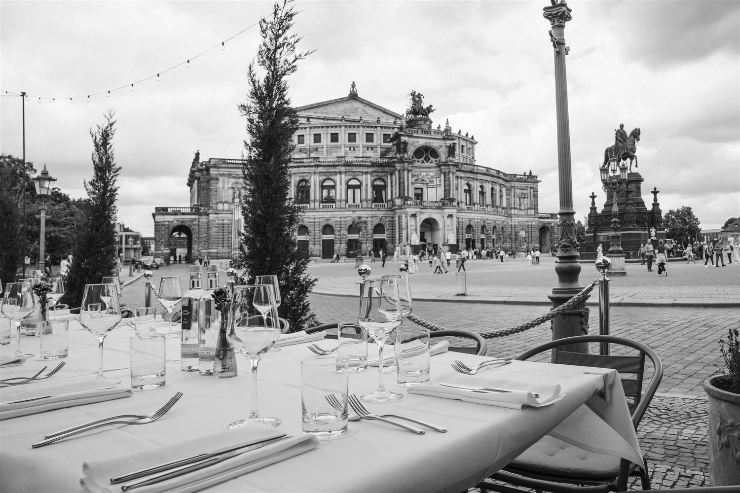 Panoramic black and white collage showing transforming views of the Semperoper opera house in Dresden over time periods.
