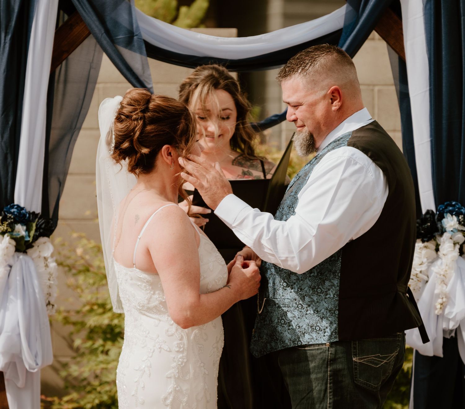 Couples sharing intimate first dances at an elegant wedding reception with draped white fabric decor.