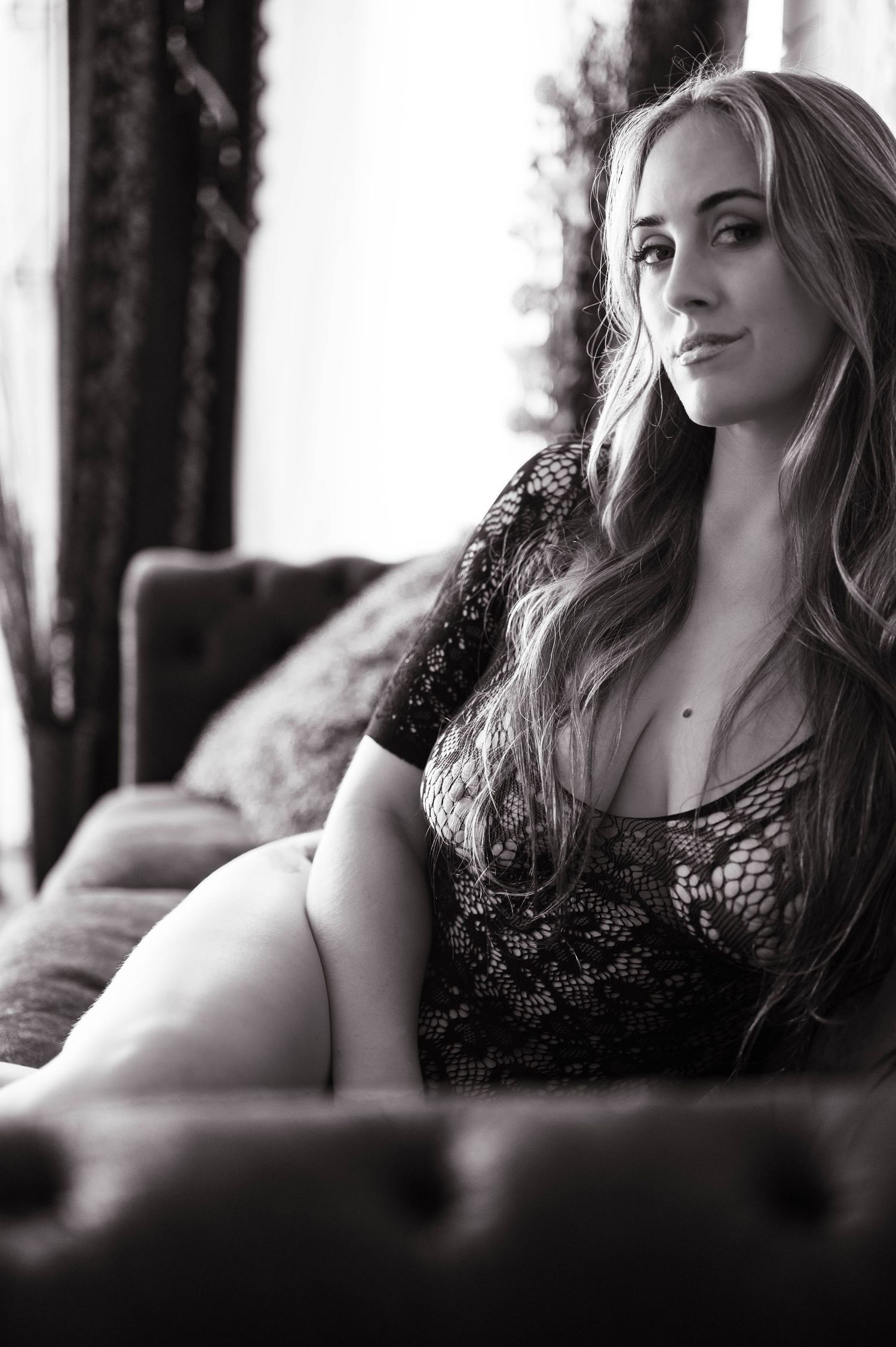 Moody black and white boudoir photos with dramatic lighting and lace details.