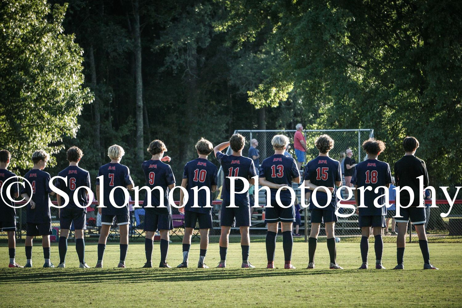 Patriot soccer team lines up from behind on the field before their match, photographed by Solomon Photography.