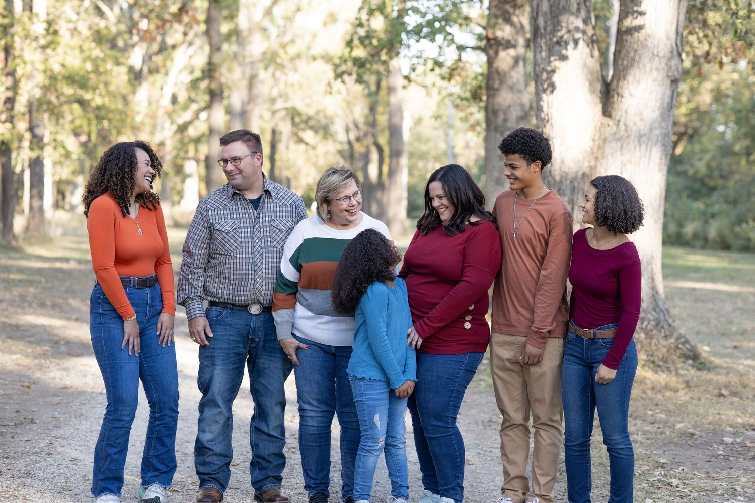 Springfield, IL family photographer captures an extended family smiling at each other during a photo session in Central, IL