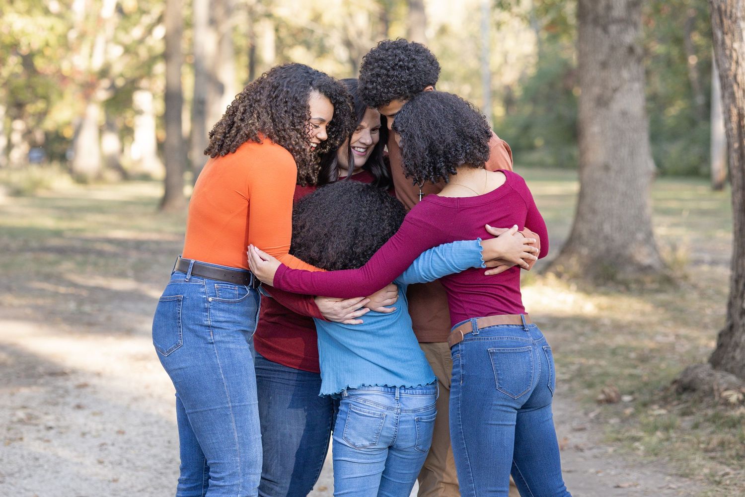 Springfield, IL family photographer captures a family hugging during a photo session in Central, IL