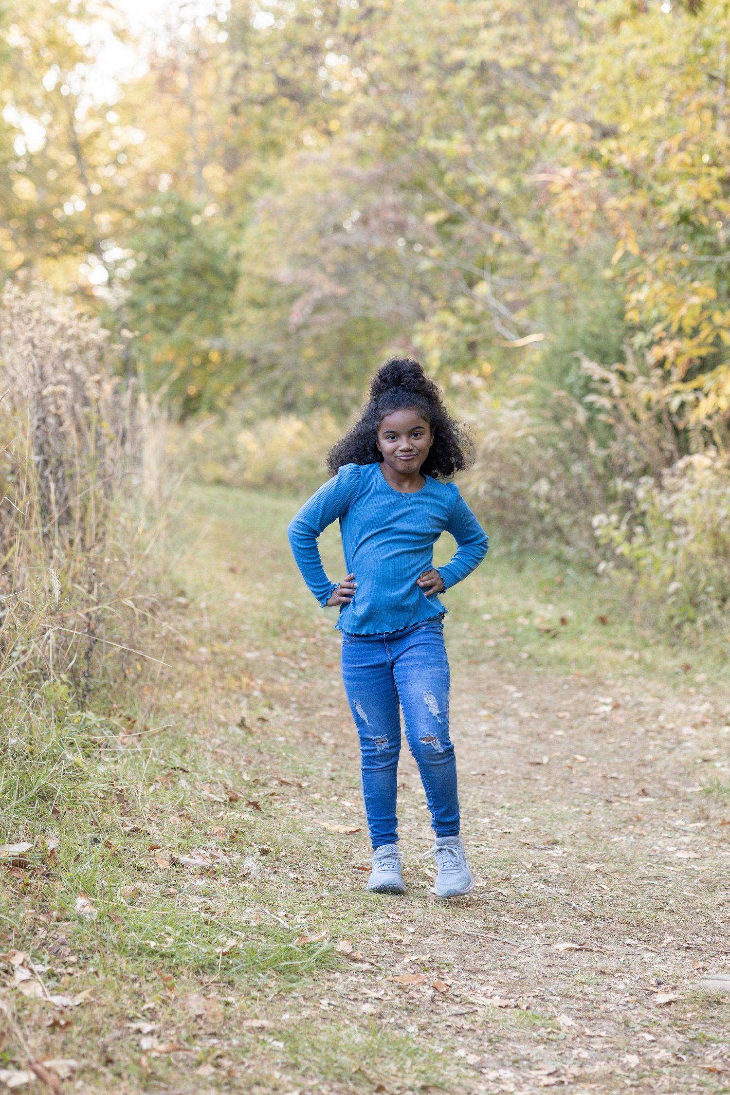 Springfield, IL family photographer captures a young girl on a trail during a photo session in Central, IL