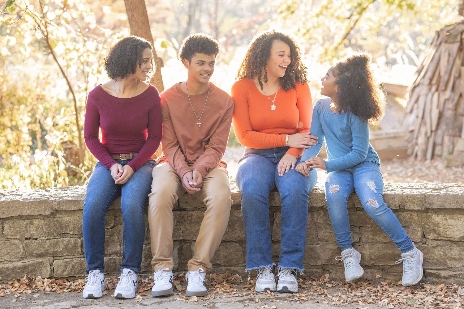 Springfield, IL family photographer captures four siblings sitting together during a photo session in Central, IL