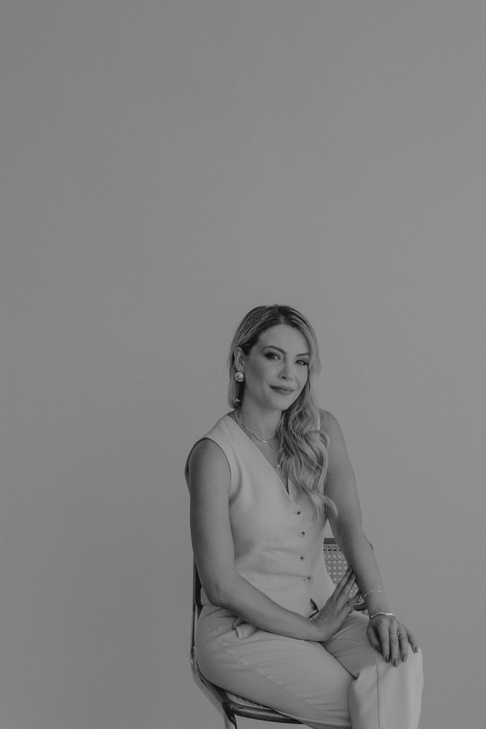 Black and white portrait series showing a person in casual attire posing against a simple background.
