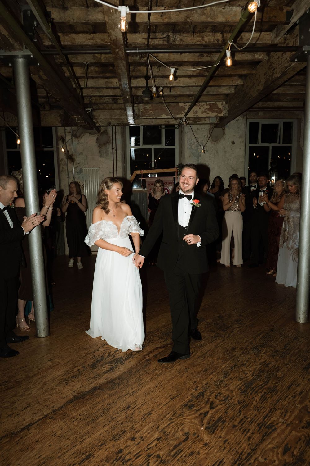 intimate moment of couple on dance floor with direct flash, bold editorial-style wedding photo at Holmes Mill by Manchester photographer
