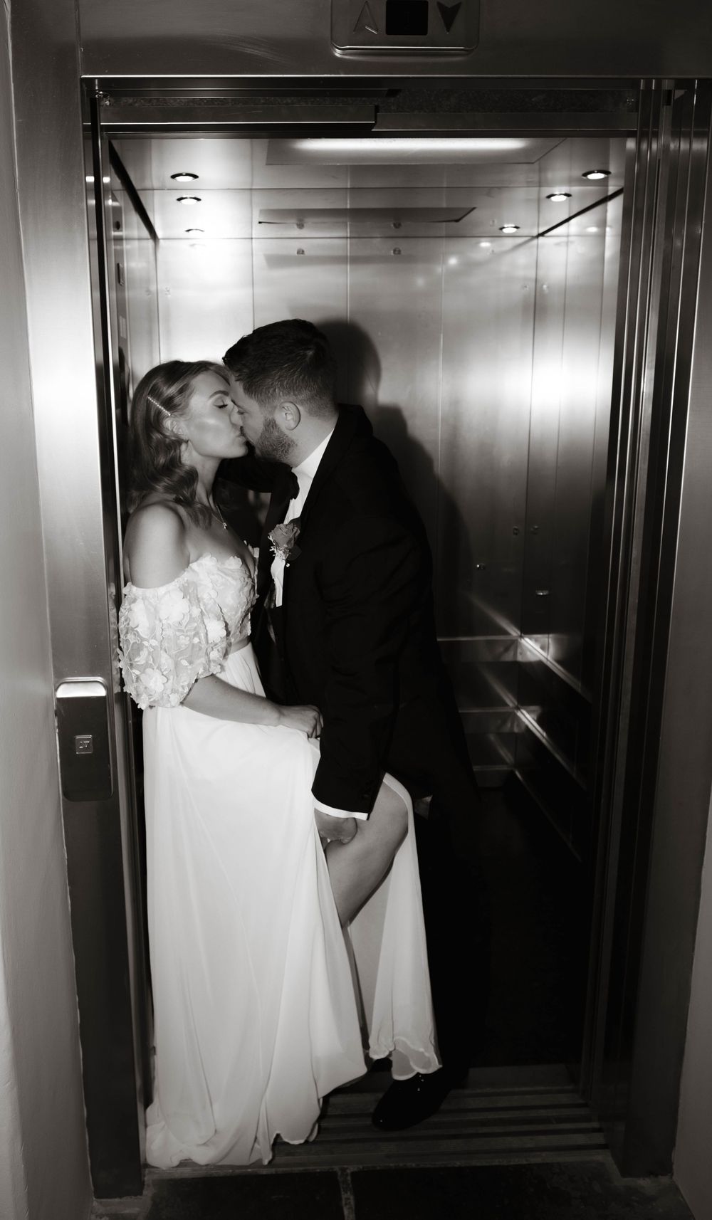 Spicy elevator shot of wedding couple at Holmes Mill, trendy editorial flash wedding photography by Manchester-based photographer.