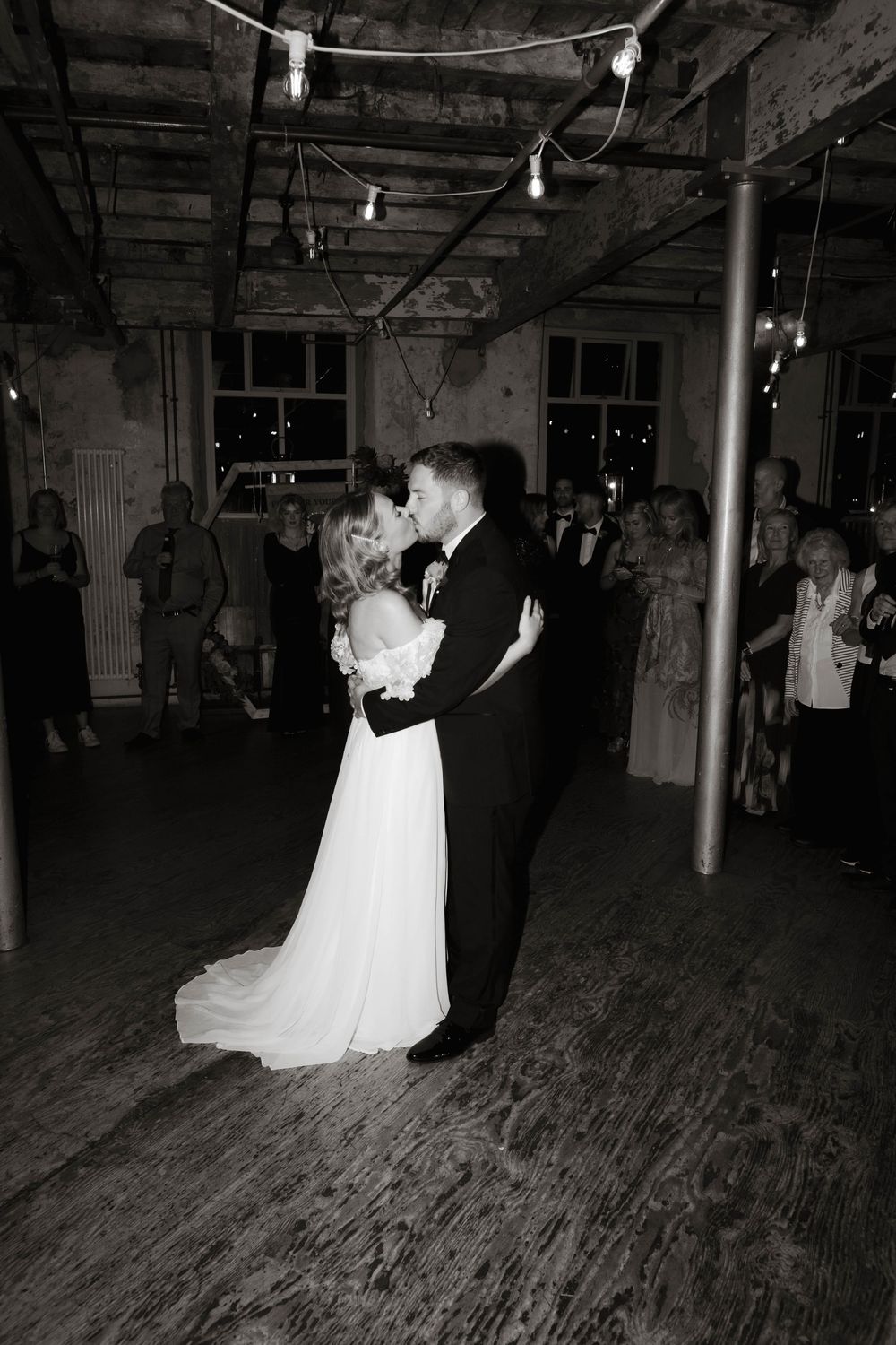Bride dancing during reception at Holmes Mill, flash photo capturing candid moment by editorial-style wedding photographer in Manchester