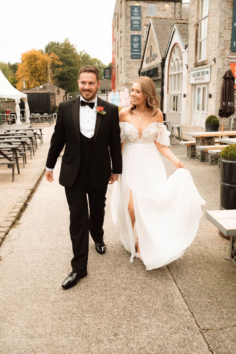 Bride walking and swinging her dress in a candid editorial wedding portrait, captured by Manchester documentary wedding photographer.