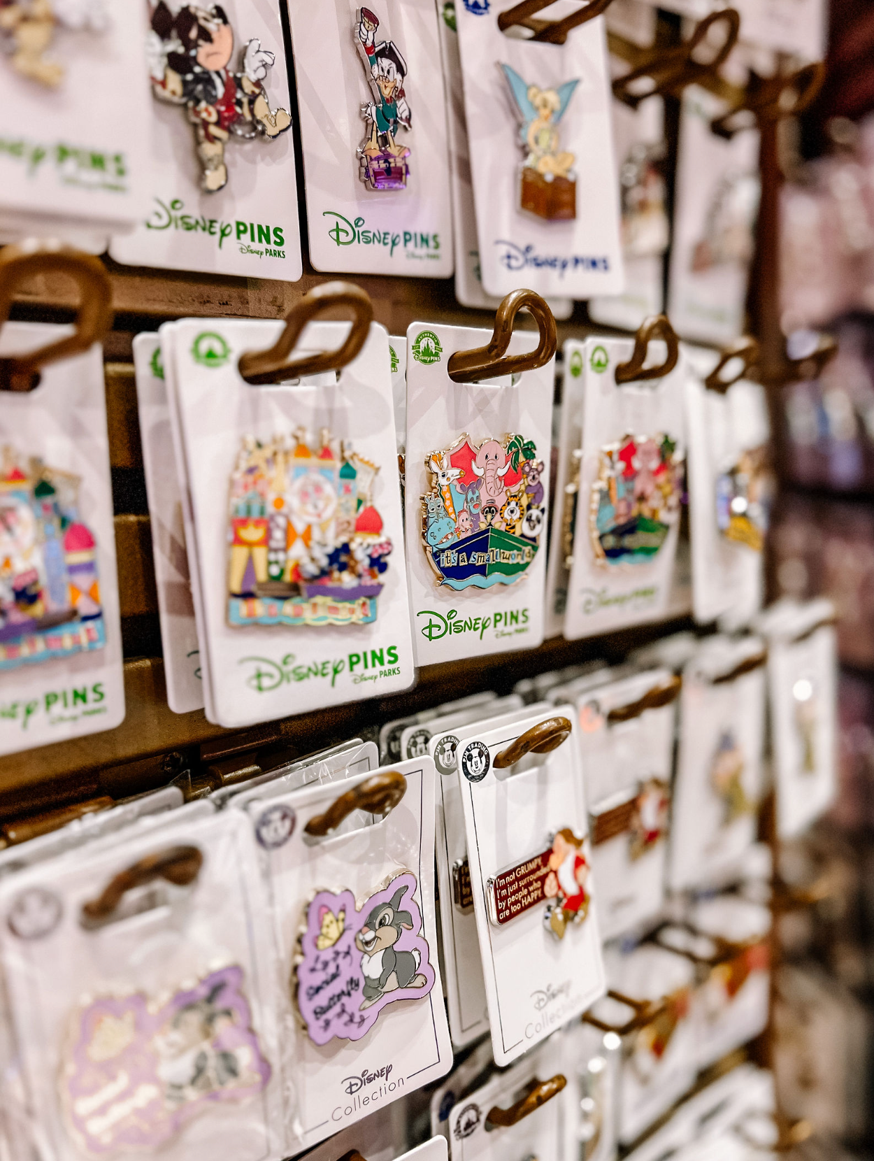 Display case filled with rows of official Disney pins for trading and collecting.
