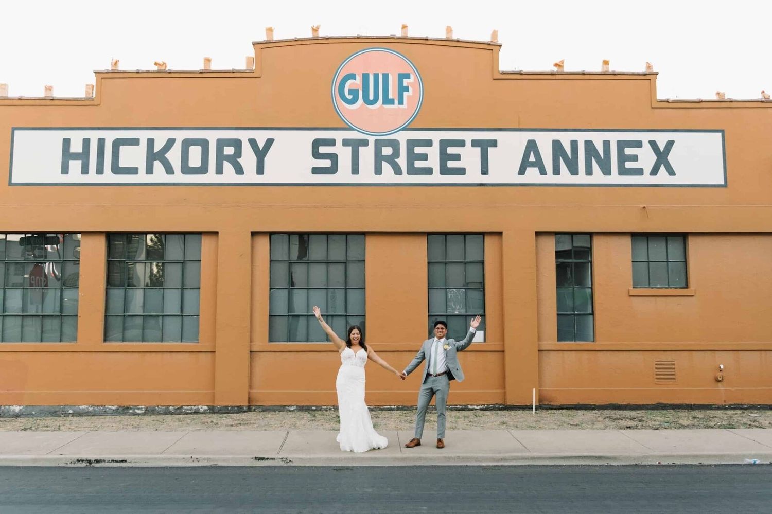 Couple poses with a street mural at Hickory Street Annex, a Dallas wedding venue