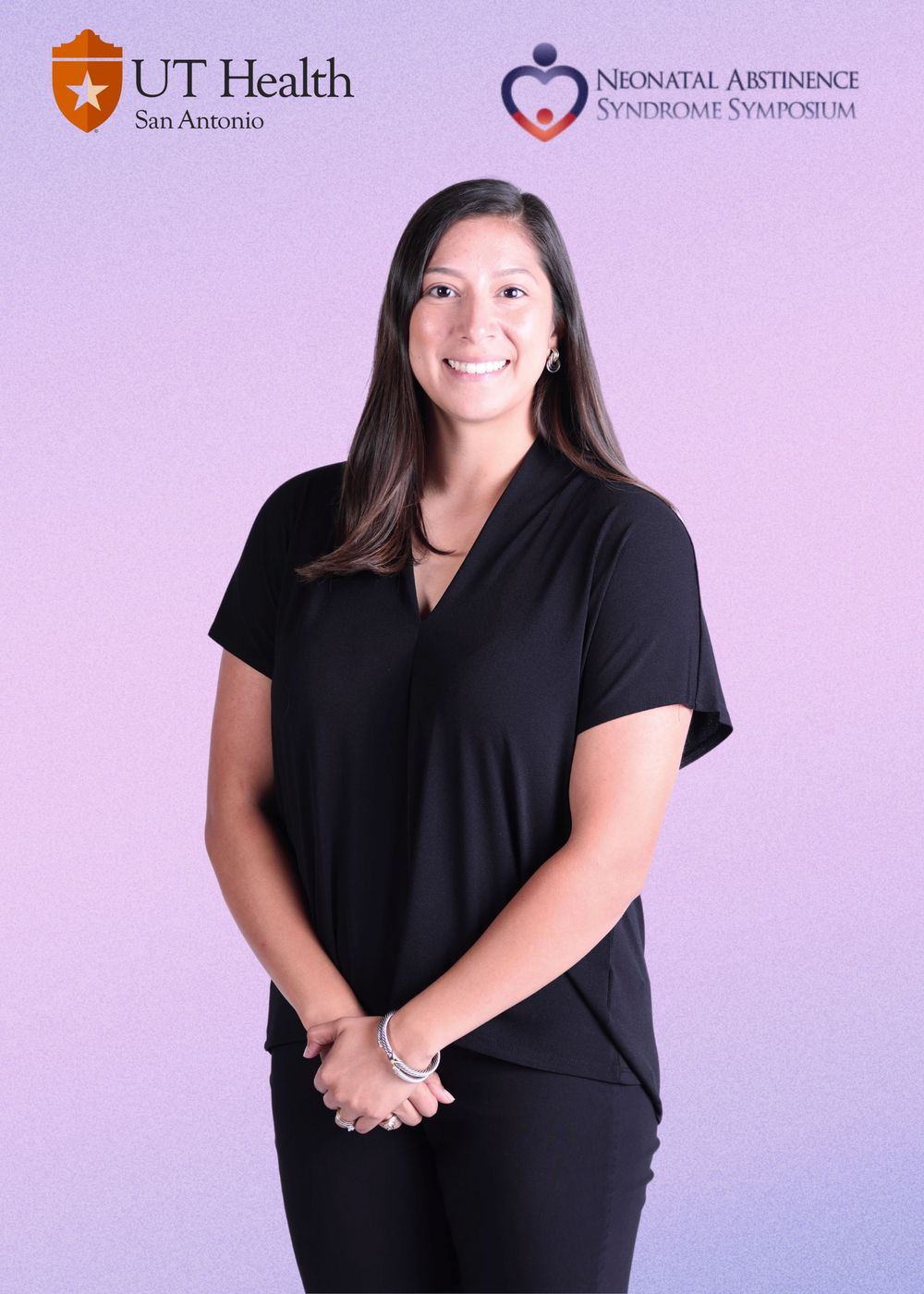 Healthcare professional in black scrubs poses for a portrait against a purple gradient background with UT Health San Antonio logo.