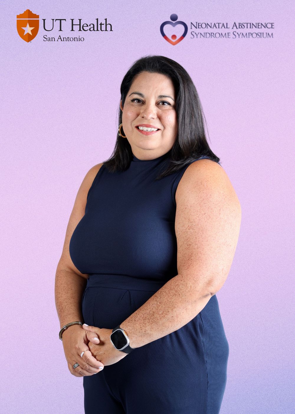 Four profile views of someone in a sleeveless navy dress and smart watch posing against a purple backdrop.