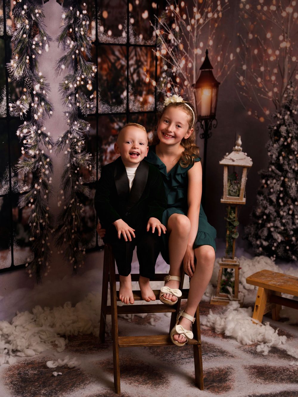 A series of studio photos featuring winter scenery with glittering lights, rustic chairs, and flocked holiday decor.