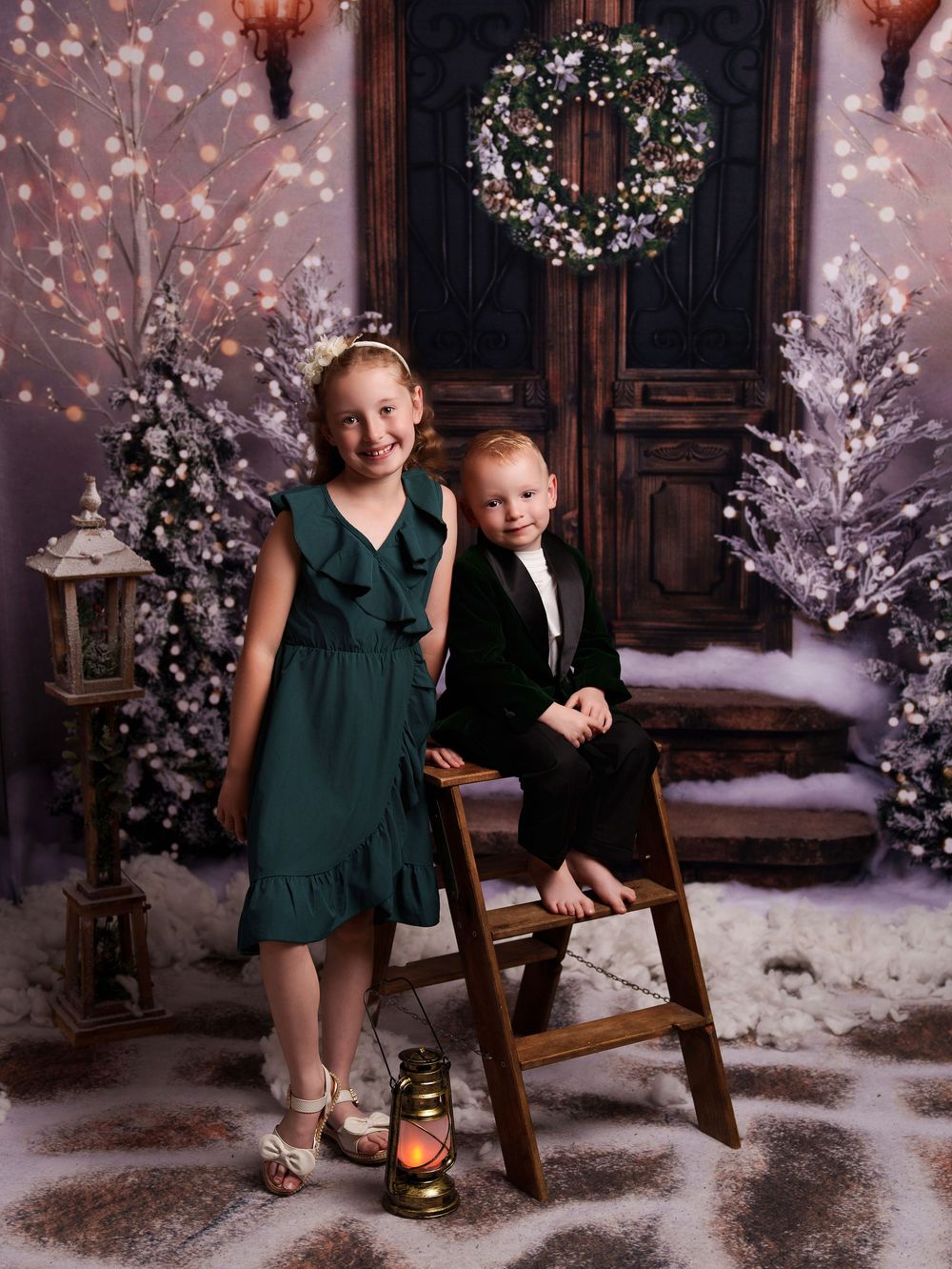 Children sit together on a rustic wooden bench in a magical winter wonderland setting with twinkling lights and snow.