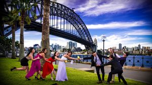 Five colorful wedding photos combined into a panoramic view of Sydney Harbour Bridge and Opera House.