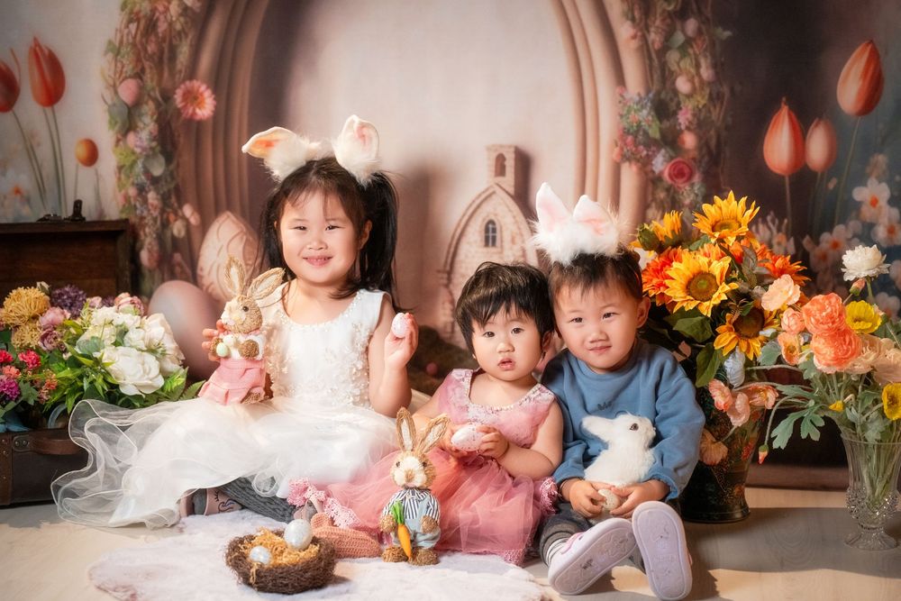 Joyful Easter mini session featuring kids and family portraits with a beautiful spring floral backdrop, captured by an Auckland family photo