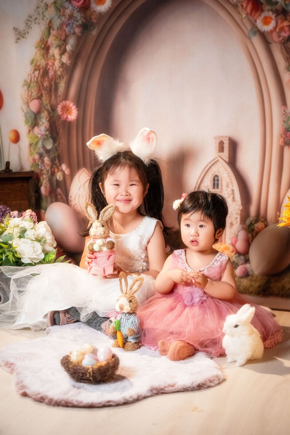 Joyful Easter mini session featuring kids and family portraits with a beautiful spring floral backdrop, captured by an Auckland family photo