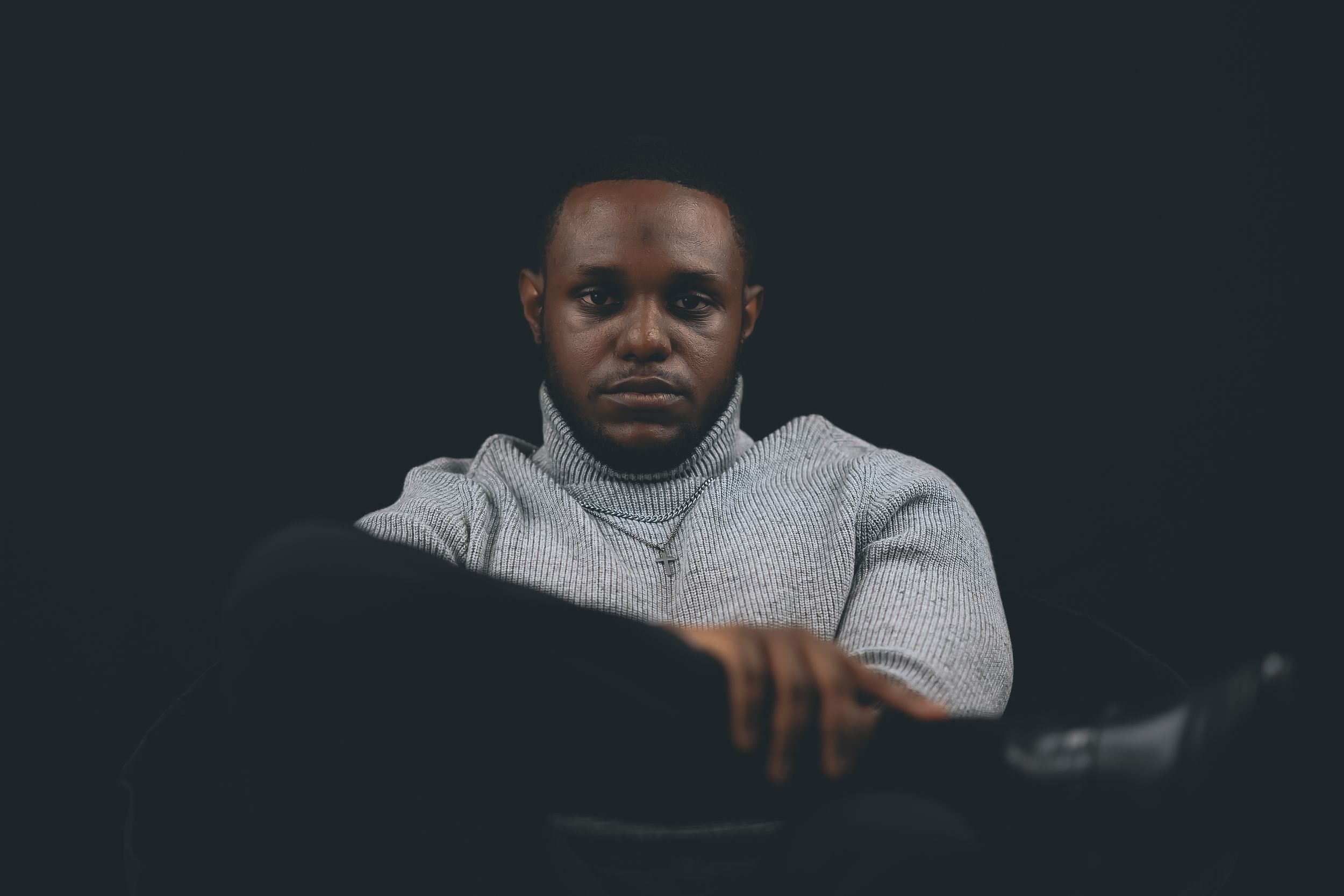 Five black and white portrait photos showing different facial expressions and poses against dark backgrounds.