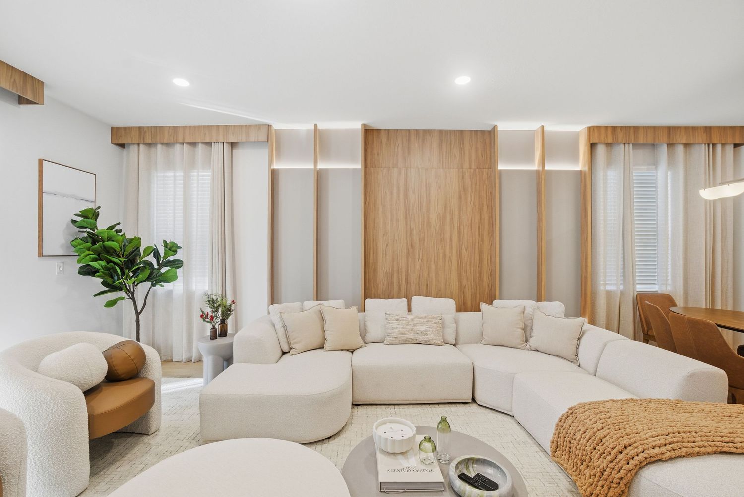 Contemporary living space with neutral tones and wooden wall panels.