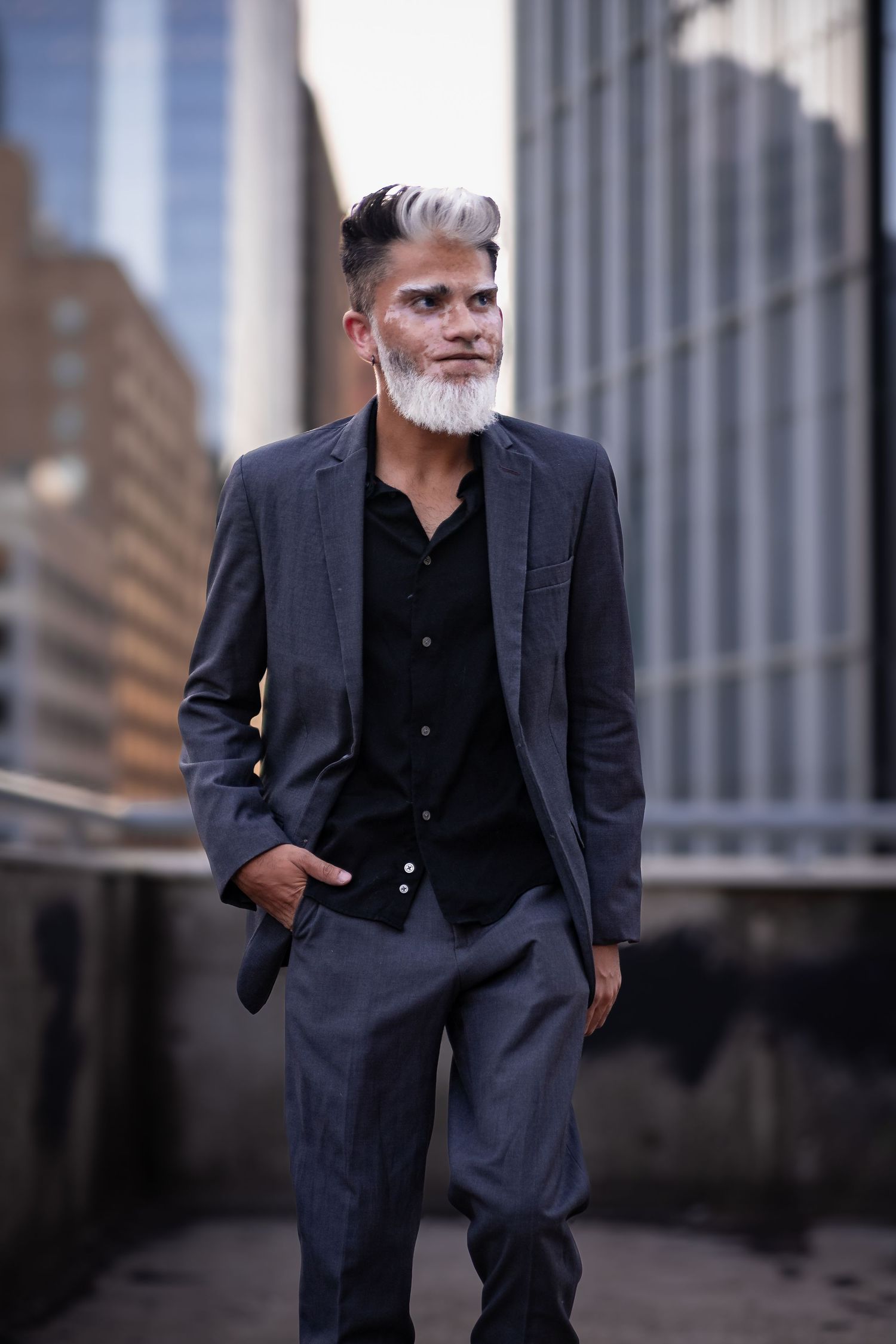 Professional portrait series showing elegant navy suit against urban backdrop.