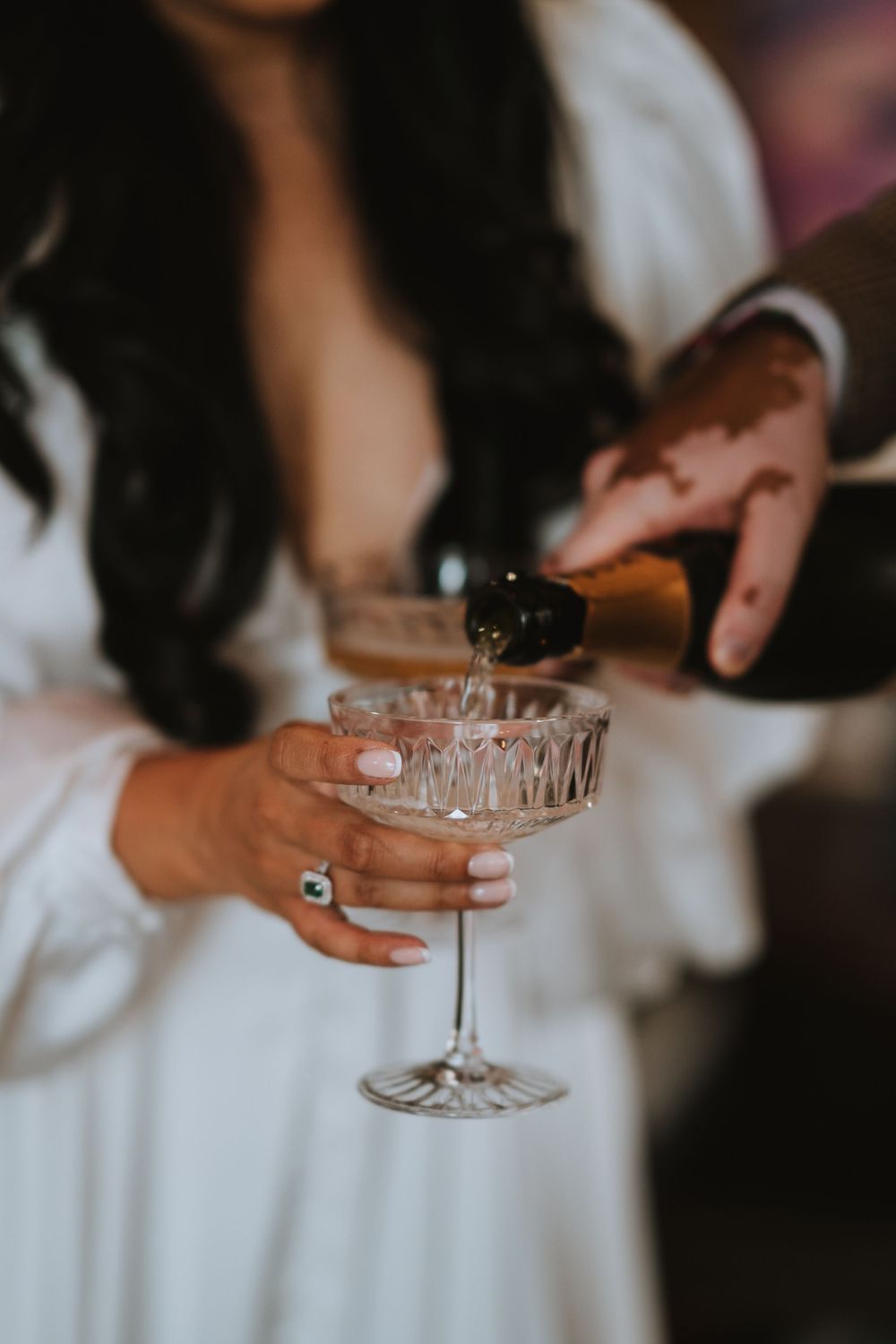 bride and groom pouring champagne