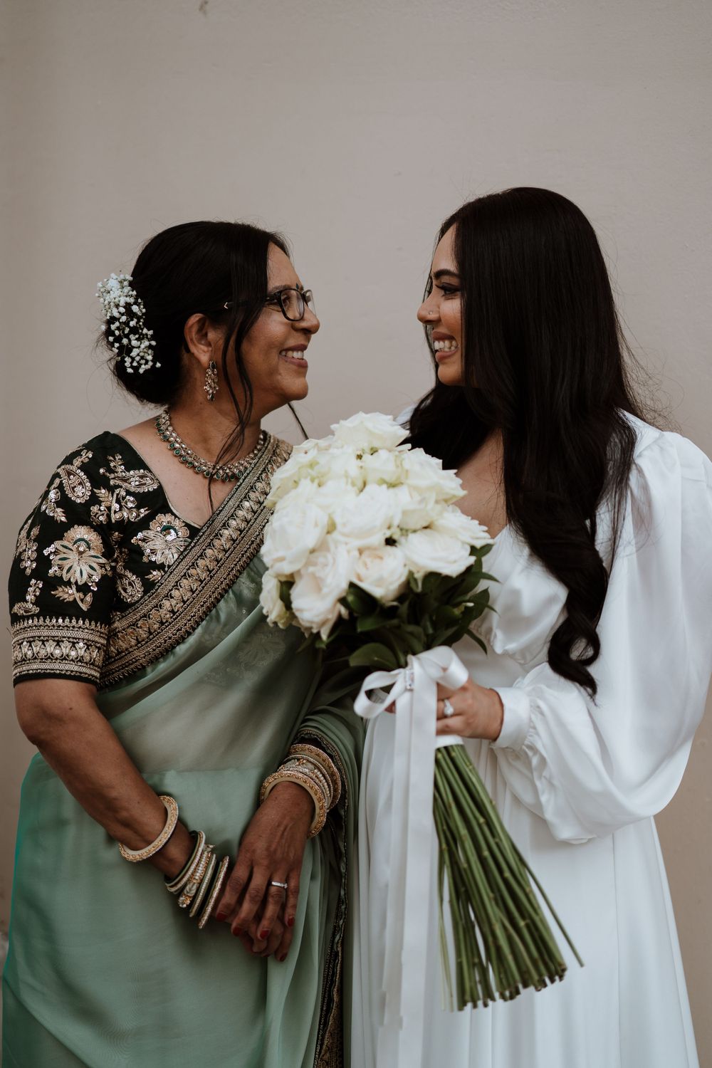 Indian bride and her mother laughing together