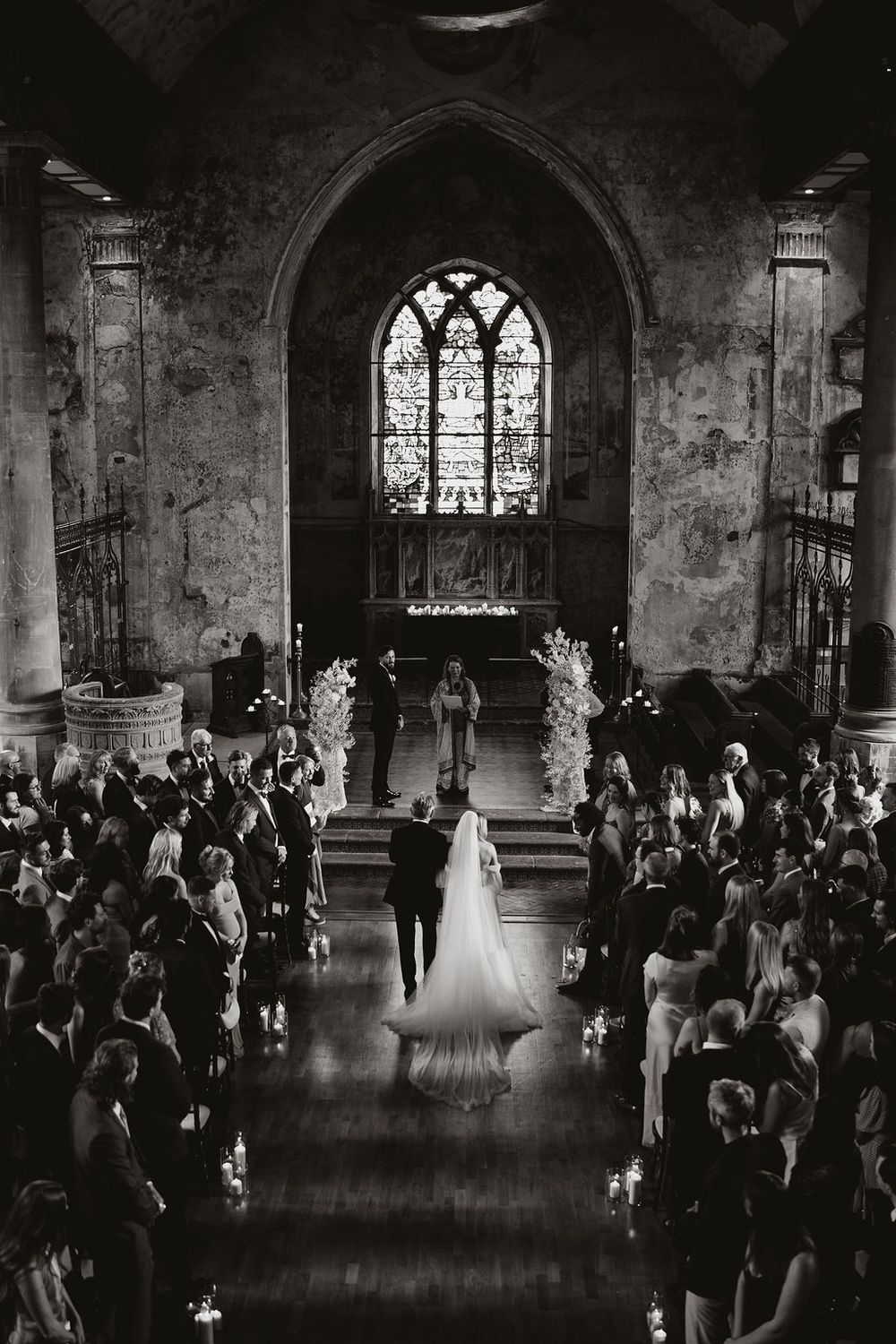 bride and groom at the end of the aisle at the mount without, surrounded by guests