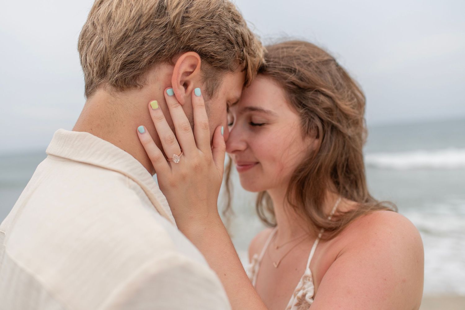 couple poses at the beach in the outer banks of North Carolina for engagement photos