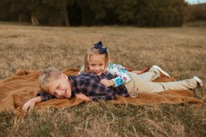 A series of photos showing a child laying on a brown horse in a grassy field.