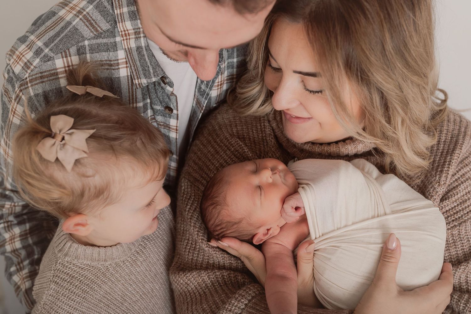 Gentle newborn photography session with parents and baby in muted earth tones. Photographer. Hull. East Yorkshire. Photography
