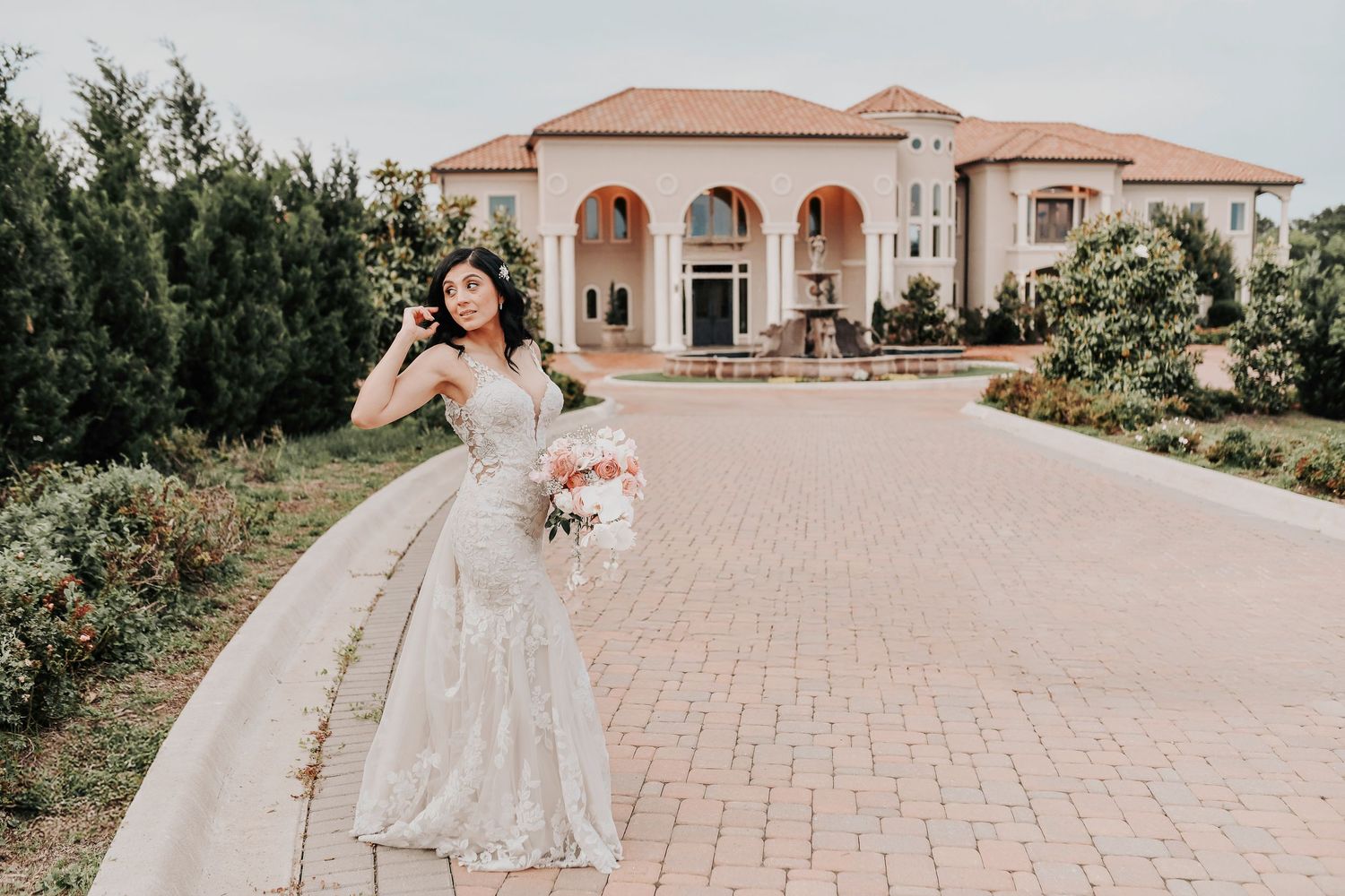 gorgeous bride poses for her wedding photos in front of her Tuscan Wedding Vineyard in McKinney