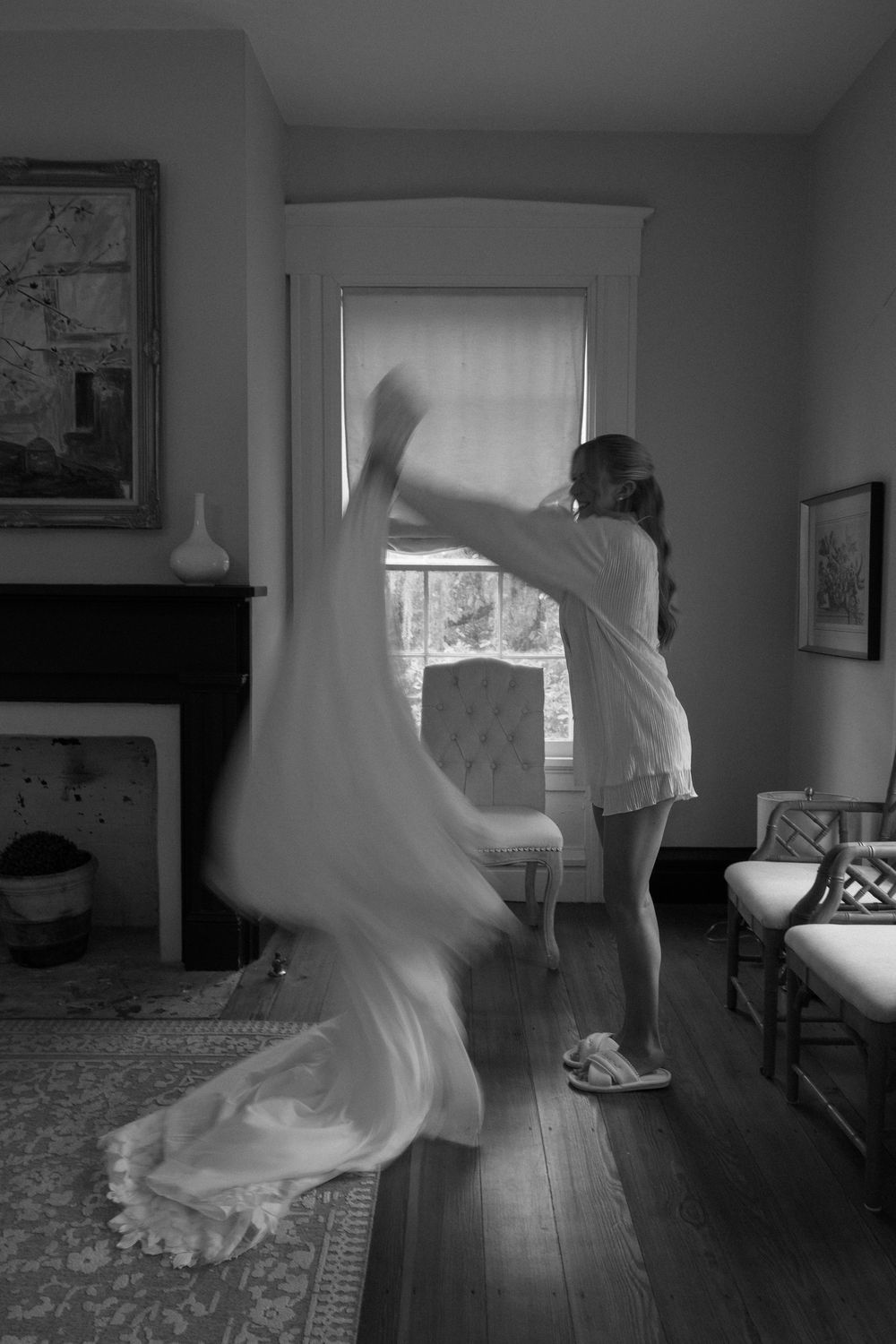 A photograph of a bride fluffing her wedding dress at The Elms of Coosada in Coosada, Alabama