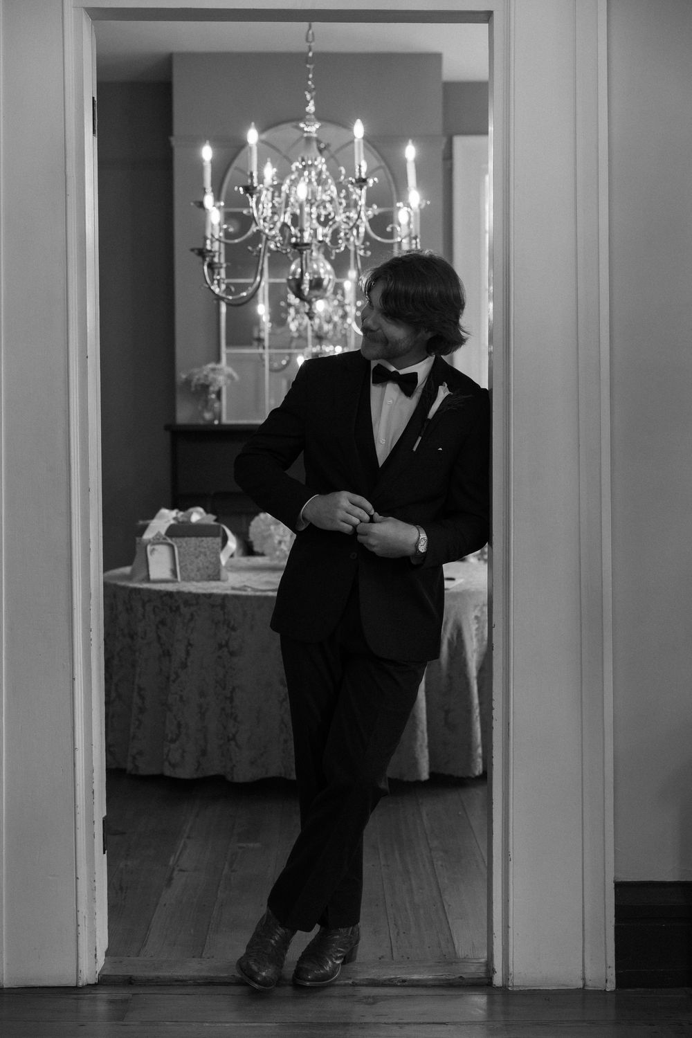 A photograph of the groom standing in the doorway at The Elms of Coosada in Coosada, Alabama