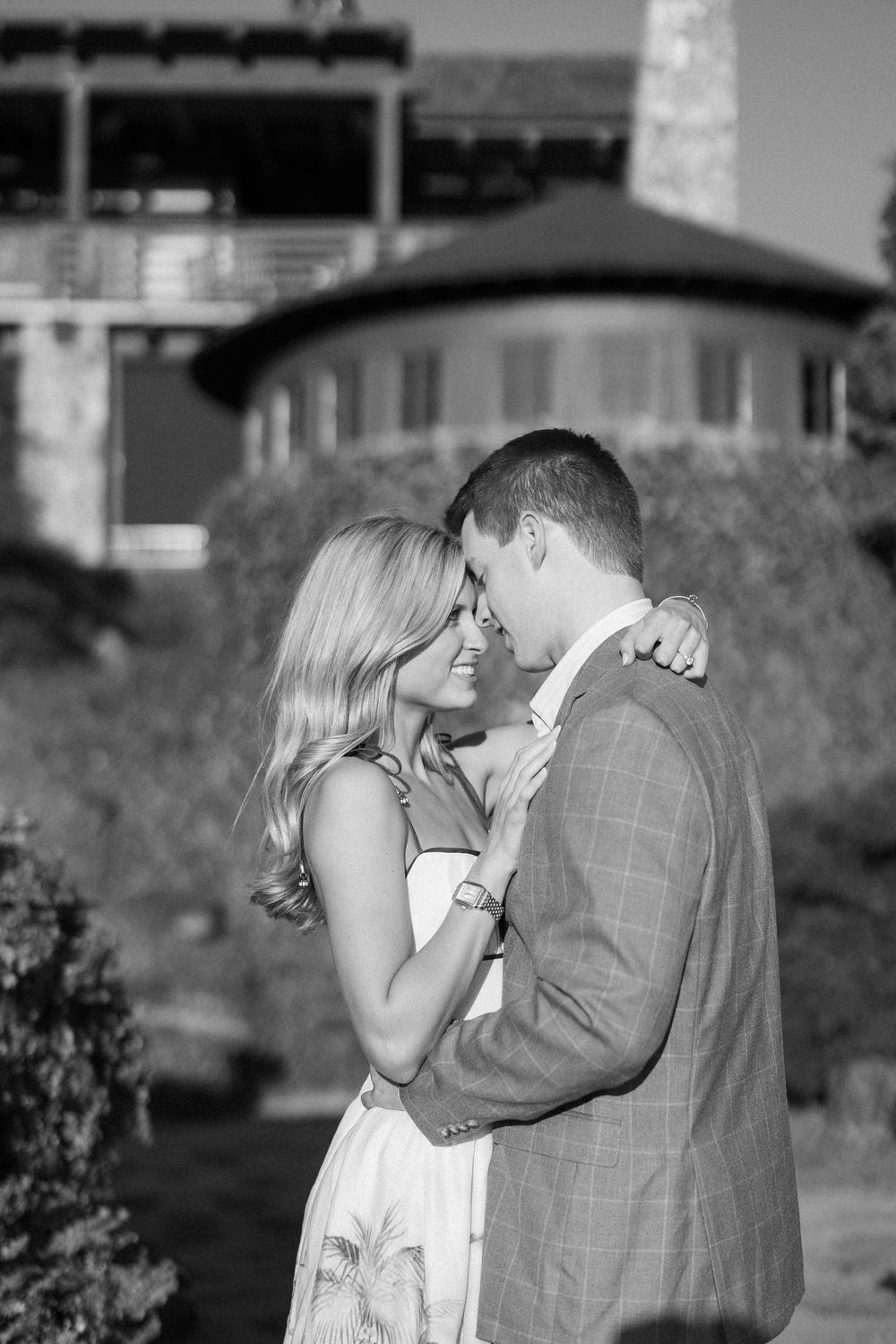A romantic black and white photo sequence shows a couple sharing tender moments outdoors.