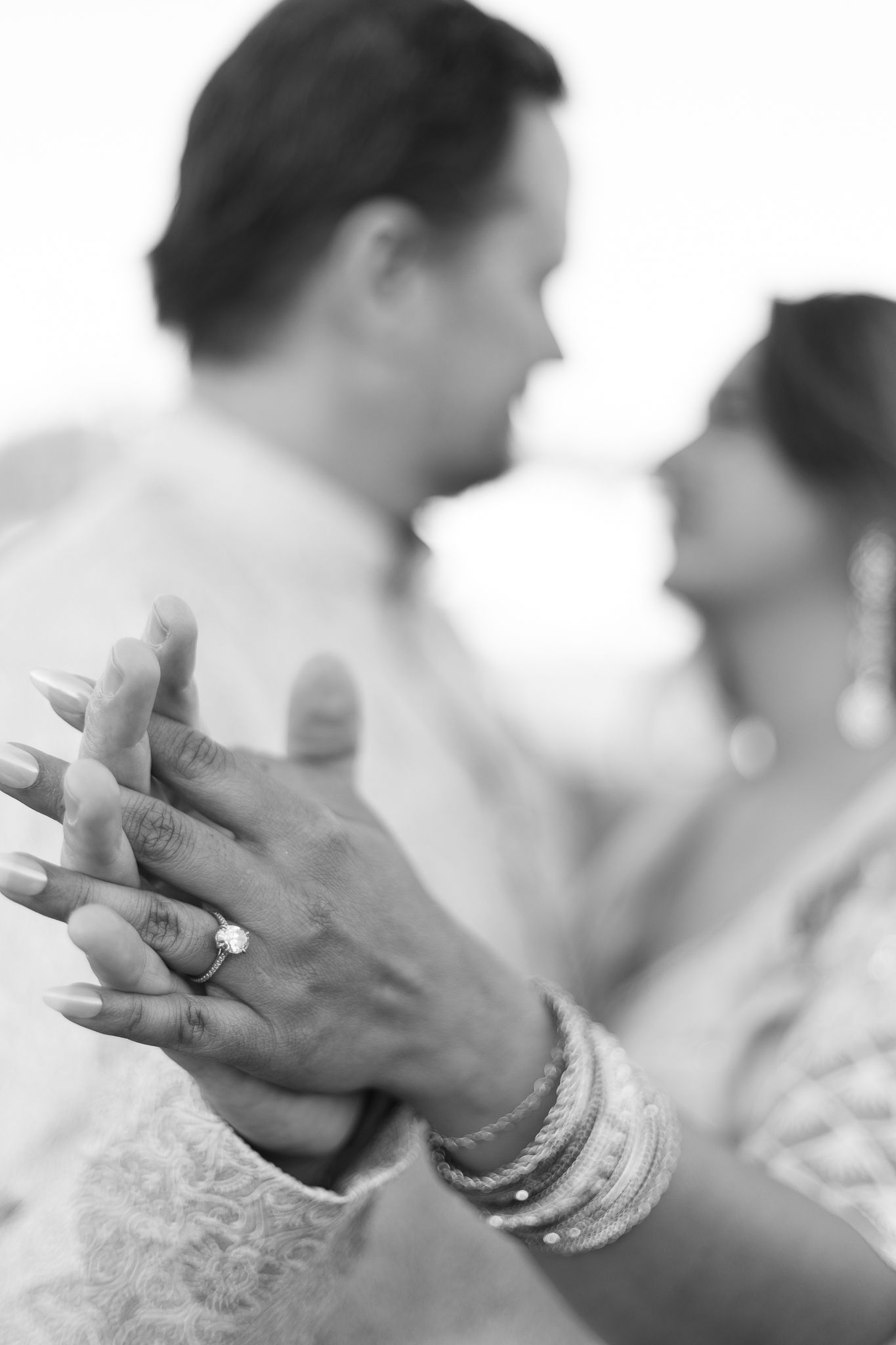 A series of black and white photos showing hands with wedding rings in different poses.