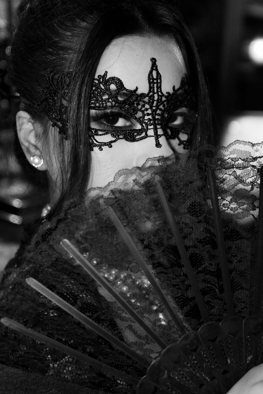 Close-up black and white portrait with intricate lace details.