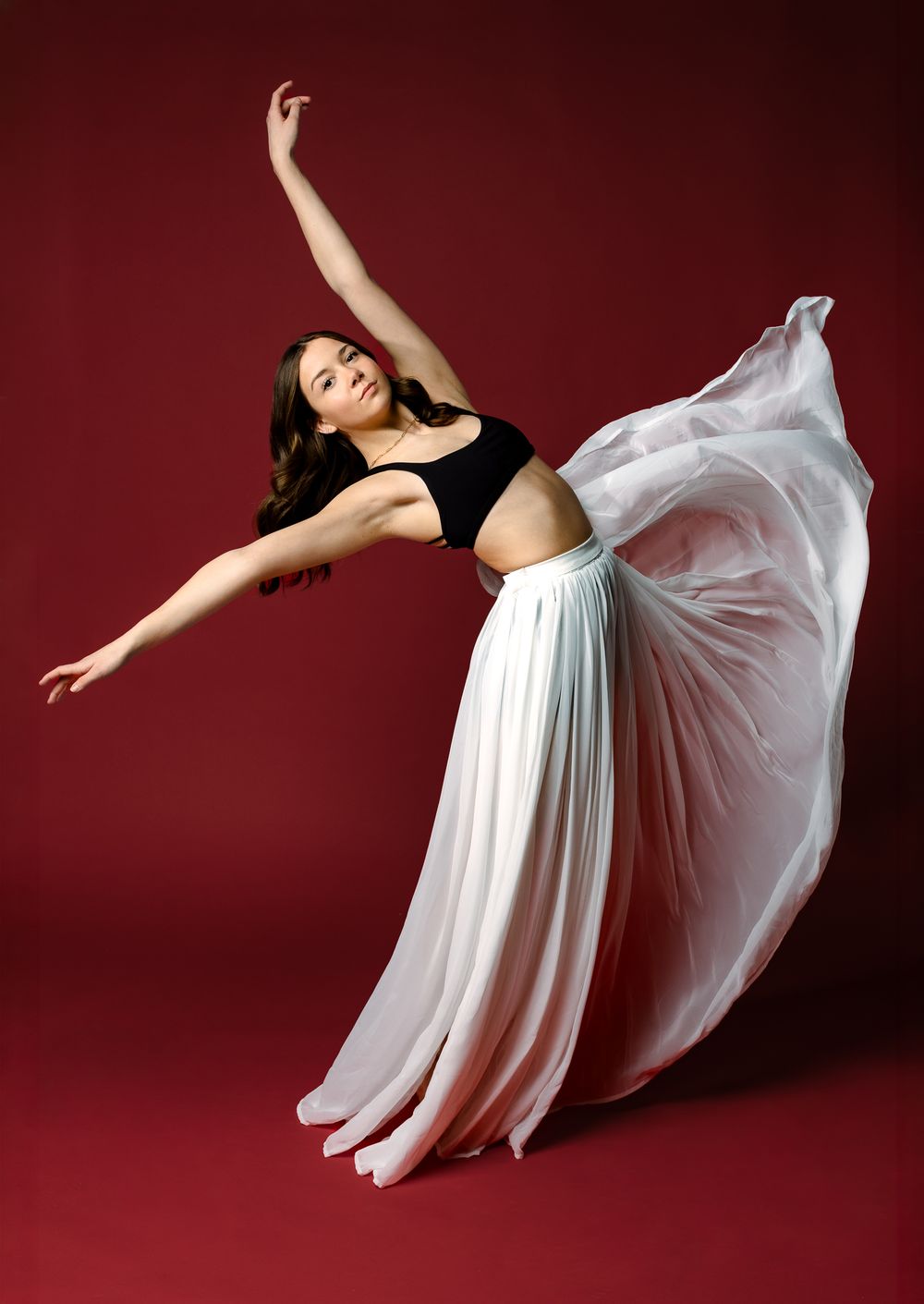 Dramatic red, black and white sequence shows a figure in motion against a dark wall with dynamic shadows.