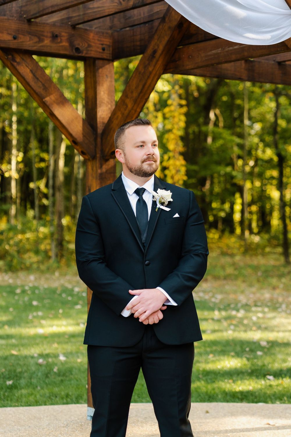 Wedding ceremony starting and the groom watching the bride come down the aisle at The Venue On Lake Grant in Mt. Orab Ohio