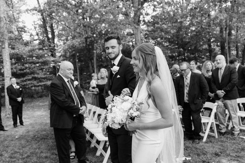 Wedding ceremony starting and the groom watching the bride come down the aisle at The Venue On Lake Grant Mt. Orab Ohio. Cincinnati Wedding