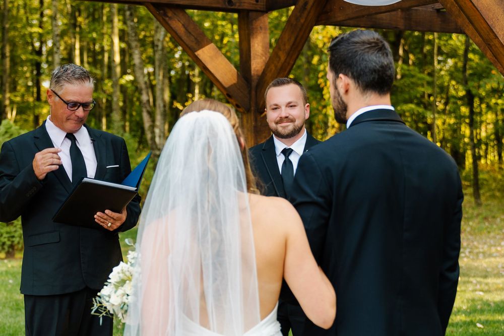 Wedding ceremony starting and the groom watching the bride come down the aisle at The Venue On Lake Grant Mt. Orab Ohio. Cincinnati Wedding
