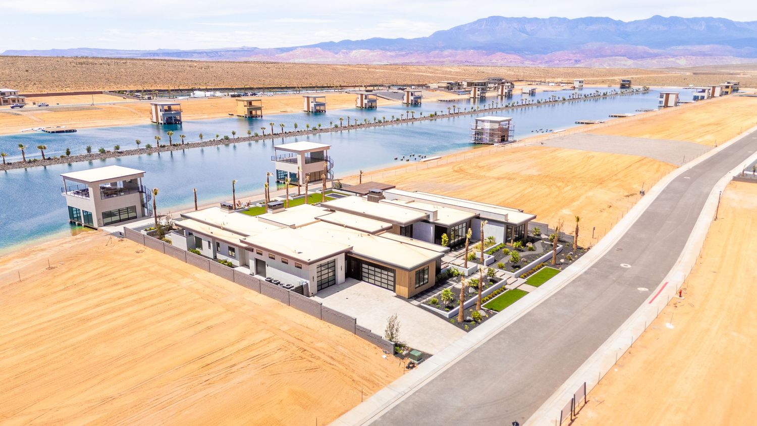 Panoramic view of Lake Mead's desert shoreline with boat docks and mountains in the background.